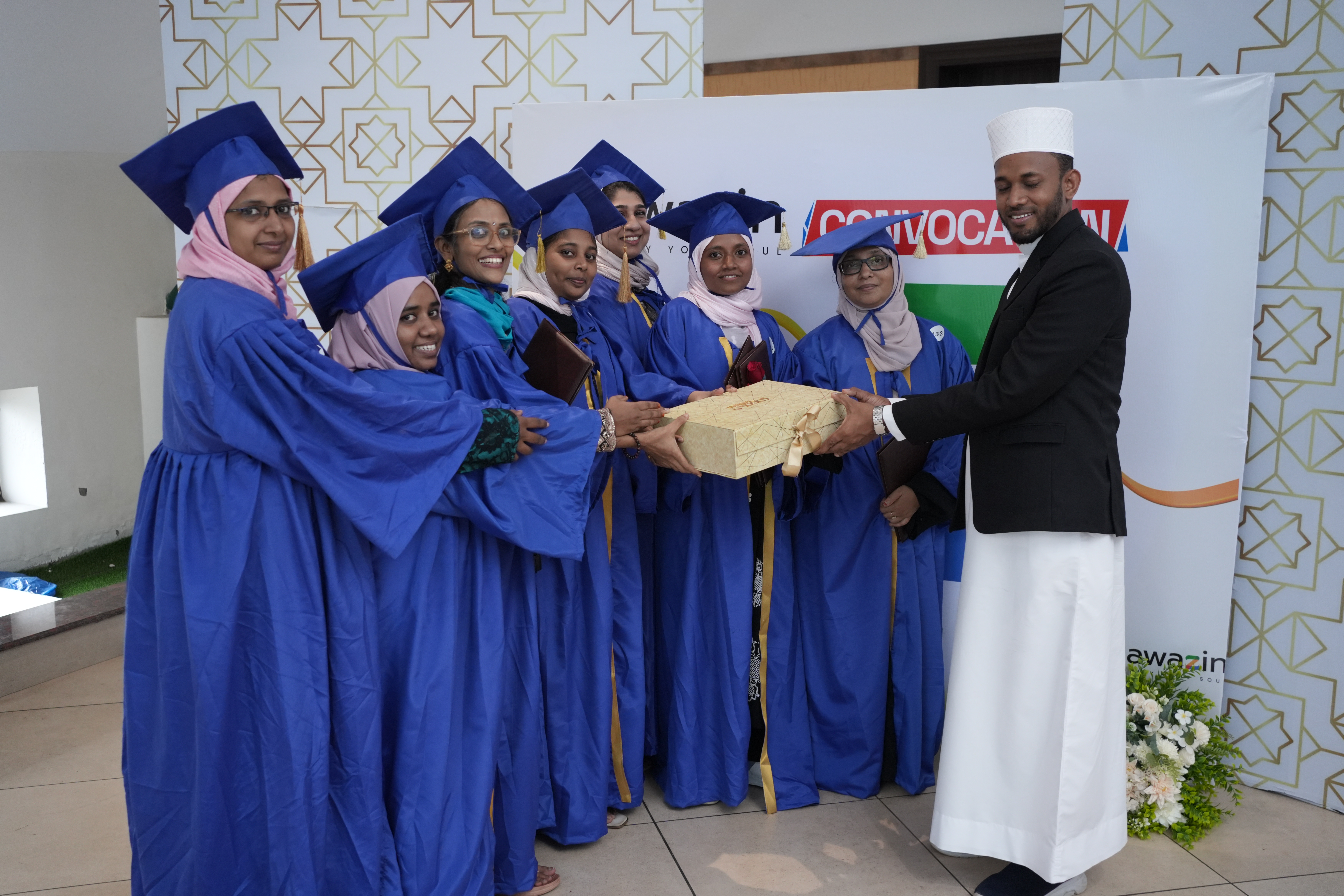 Graduates receiving a gift