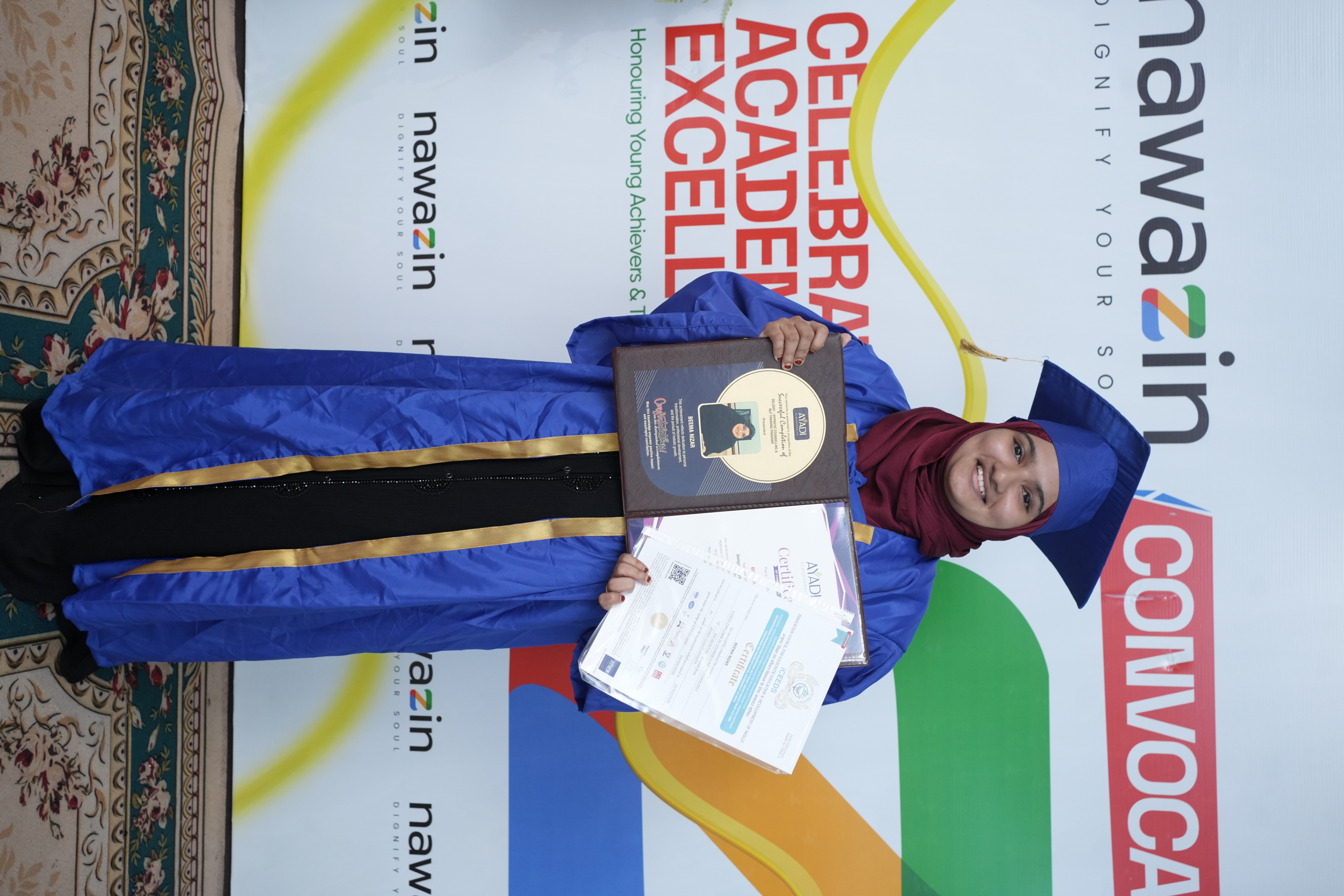 Graduate holding her certificates