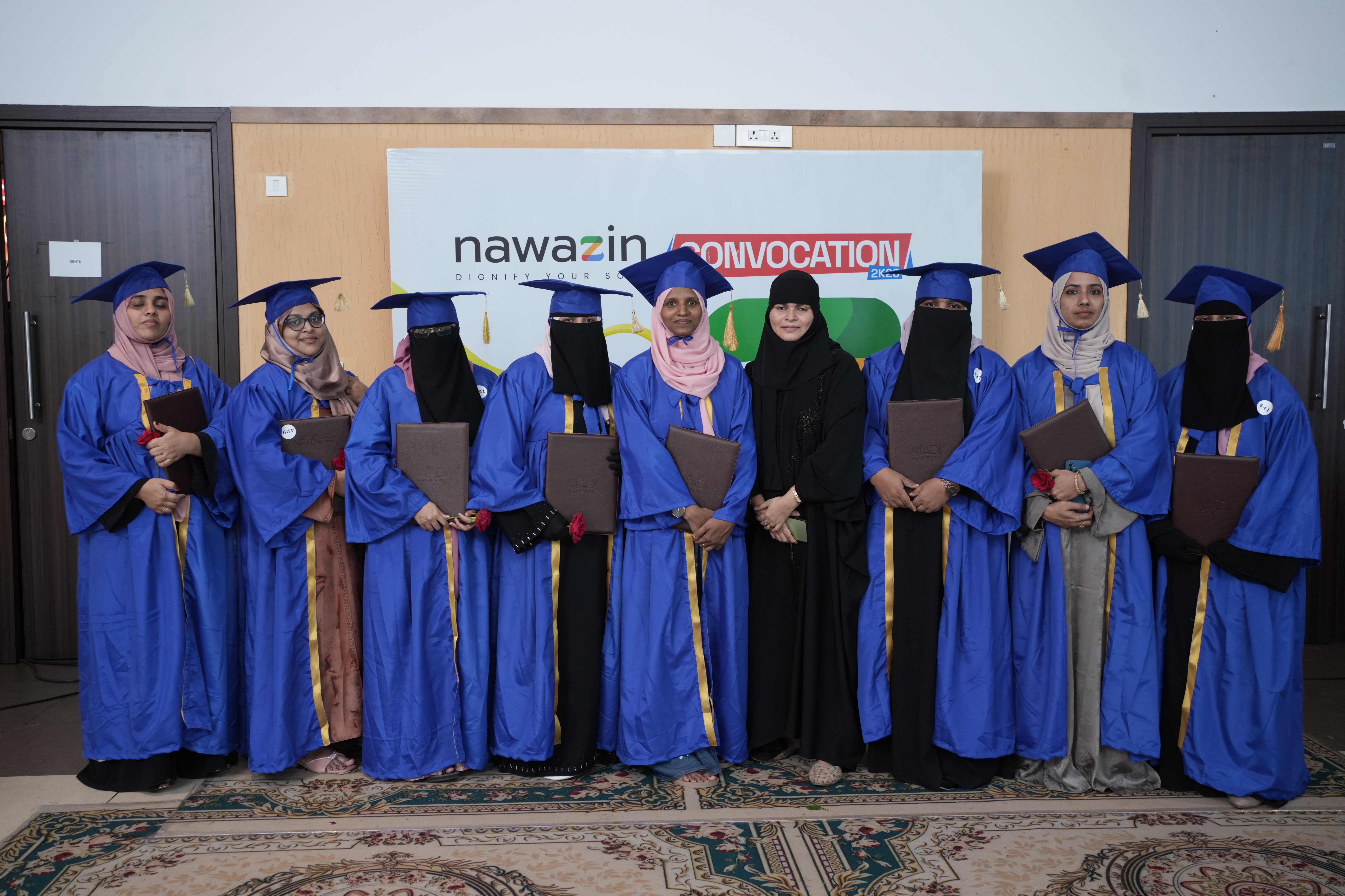 Graduates lined up with certificates